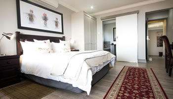 Room 1 luxury guesthouse suite with comfortable bedding, private accommodation and elegant decor at Hillside Guesthouse in Umhlanga Rocks